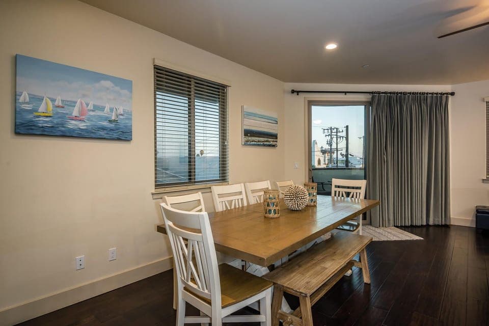 Dining for 8 plus nearby bar stools at the kitchen counter.