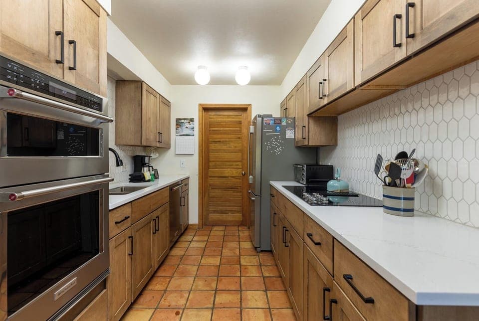 Kitchen with door to large pantry closet