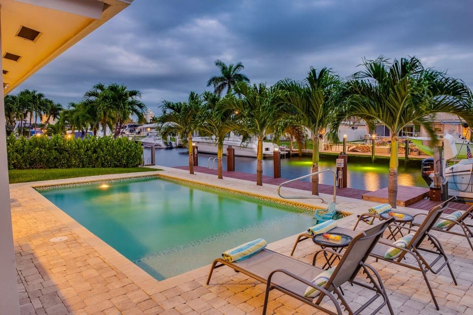 Colorful nigh time pool area set on an intracostal backdrop.