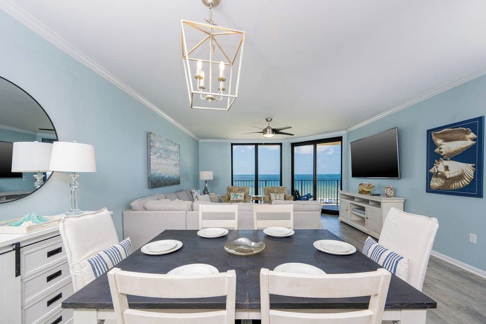 Gather around the dining table with a view, surrounded by light blue walls and comfortable seating for a relaxing stay