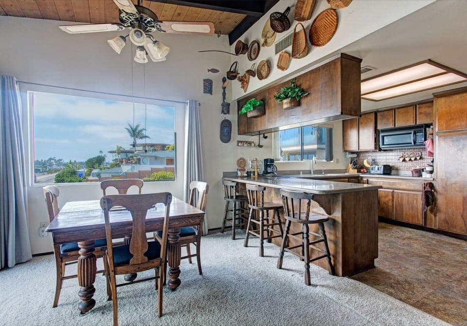 Dining area with wide windows and view of the ocean.
