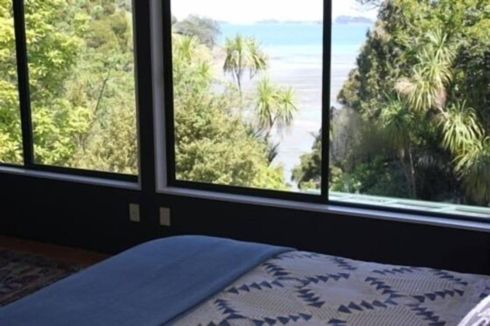 Laze in your kingsize bed and watch the sea and bush life below.