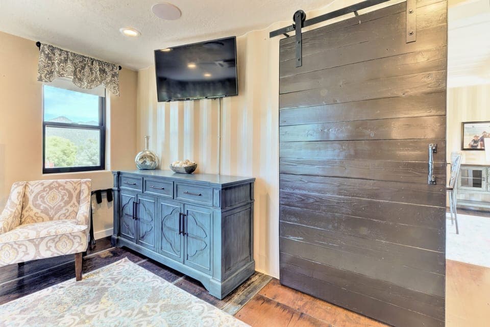 Romantic master suite and tranquil sitting area, tv and exquisite farm door. 