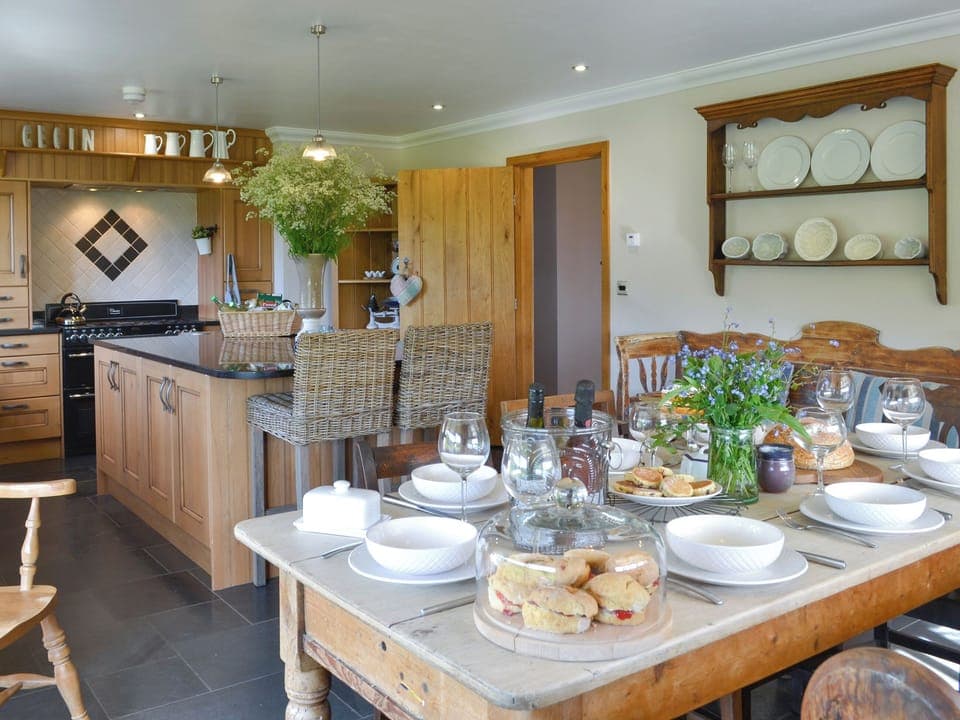 Convenient dining area within kitchen | Maes Y Bryn Farmhouse, Llansadwrn, near Llandeilo