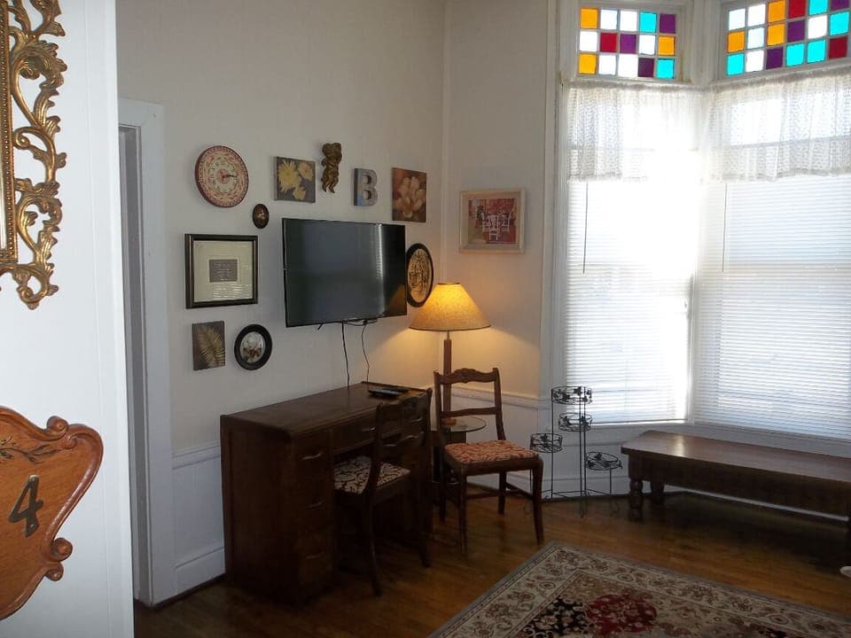 A nice workspace/desk and a flat screen TV with Roku player and Wi-Fi.