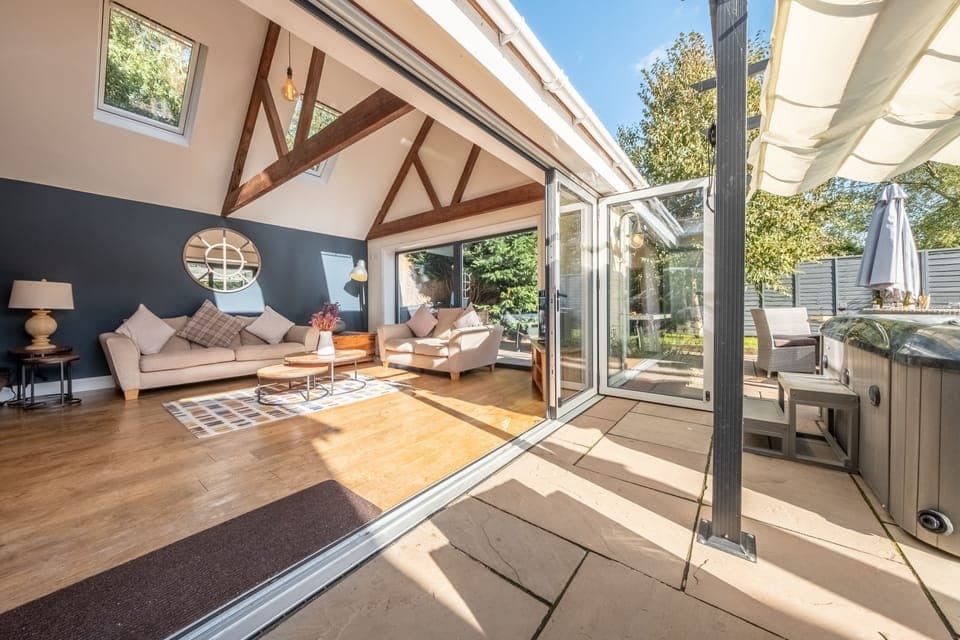 Ground floor: Further sofa area with bi fold doors leading out to the patio area and garden