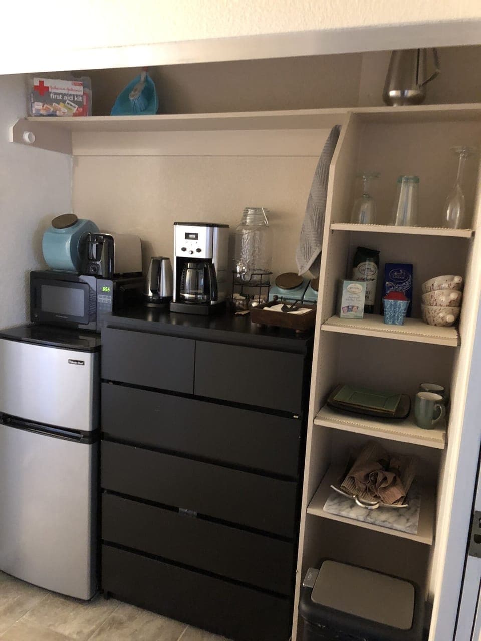 Kitchenette w/ coffee maker, microwave, refrigerator, toaster, cattle, utensils.