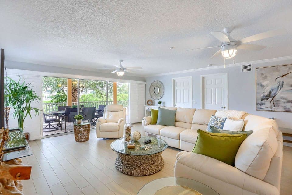 Spacious, Open Living Room with Leather Sectional Sofa, Recliner, and Flat Screen TV
