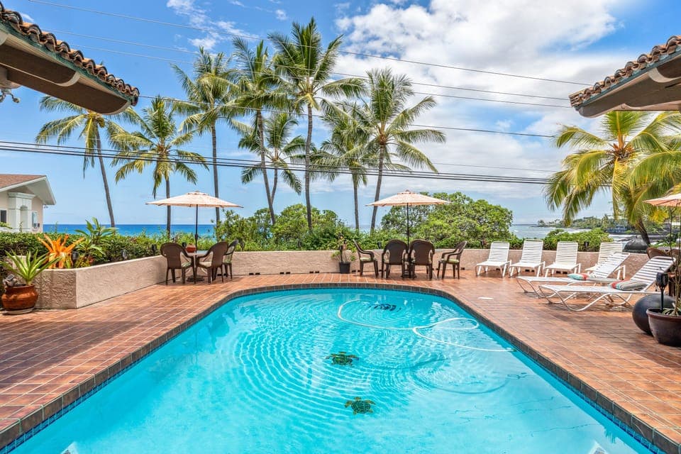 View from house across pool to the ocean, where you can enjoy beautiful sunsets