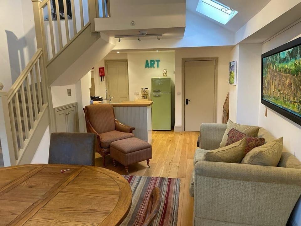 Living room and kitchen with access to upper floors.

