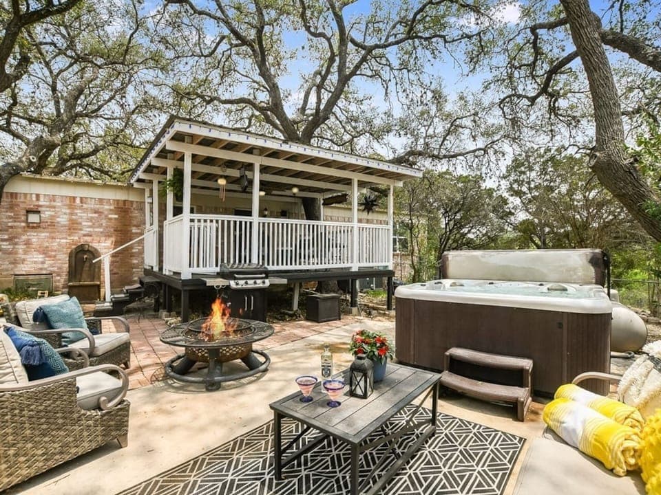 Private hot tub and great patio separated from host house by a garage. It's a 5-min walk to the lake down the driveway.Fire pit for amazing campfires and propane grill.  No direct view to water but beautiful large trees around you.