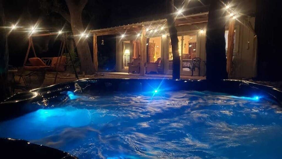 Sparkling outdoor lighting and mellow lights under the water make the hot tub a magical place at night!