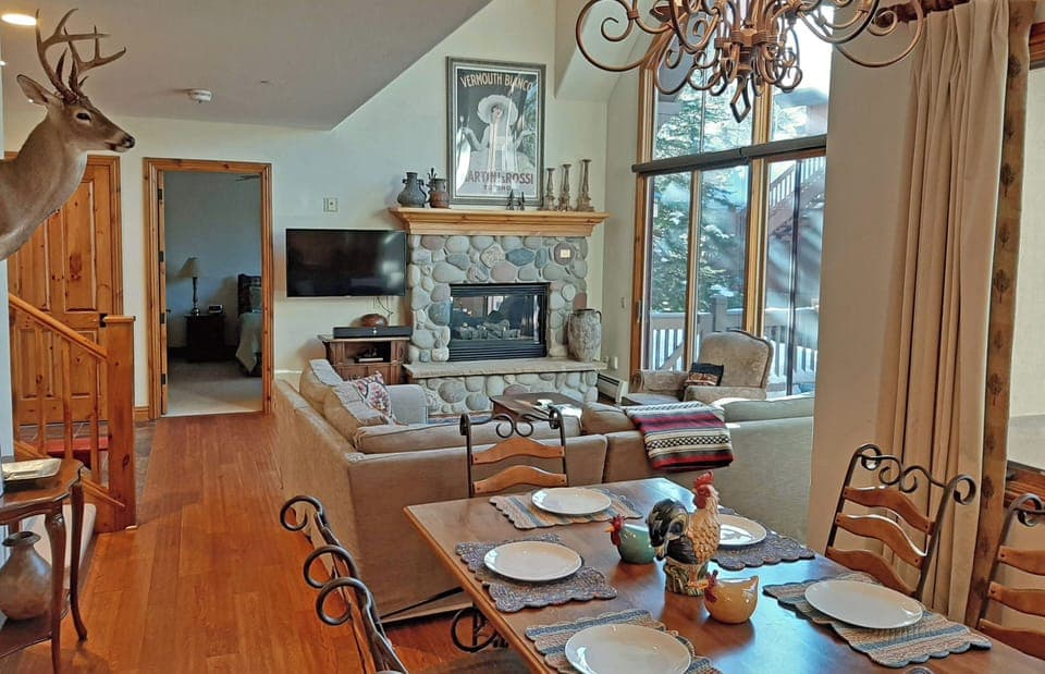 Open living area with fireplace. Walkout patio, seating for 10. 