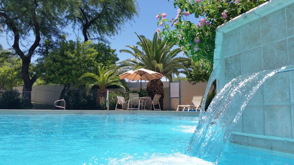 Tropical pool and Spa area with community grills.