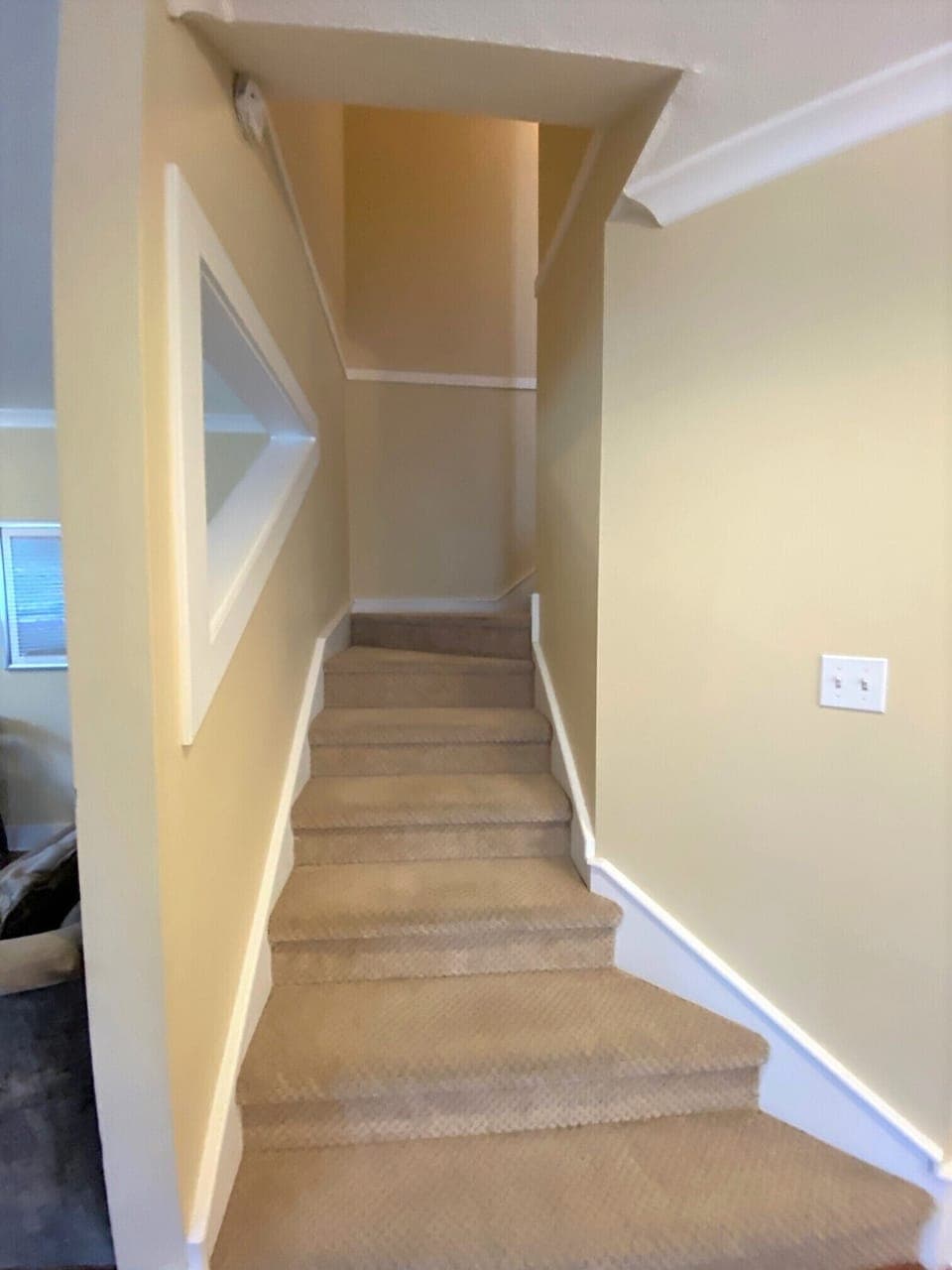 upstairs to the 3 bedrooms and 2 bathrooms