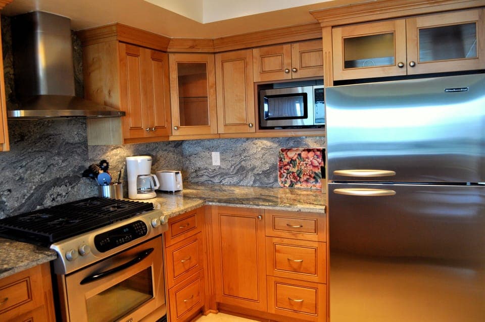 Kitchen with stainless steel appliances equipped with everyday needs