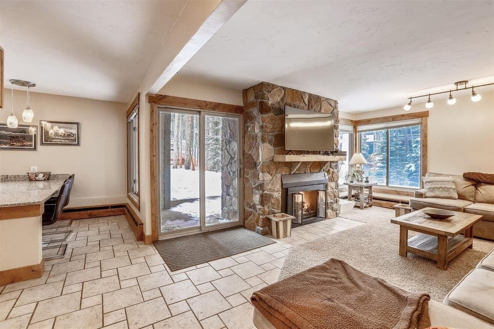 Living area with gas fireplace - Open concept living area and kitchen with patio out the glass sliding door