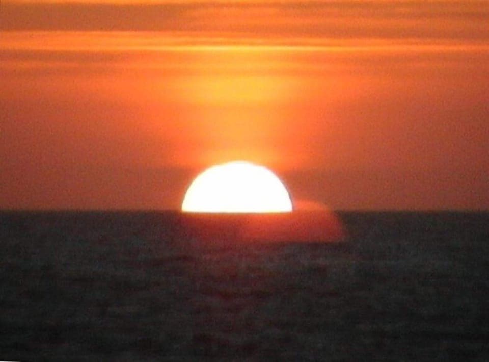 Sunset, from your windows. Go to the beach or watch the beauty from the couch.