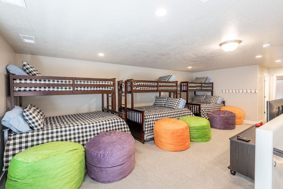 Upstairs Loft - This upstairs loft has three Twin over Queen bunk beds with twin trundles.