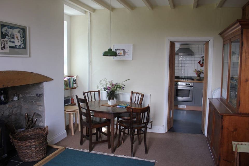 Dining Room with log burner, sofa, Welsh dresser, traditional timber walls