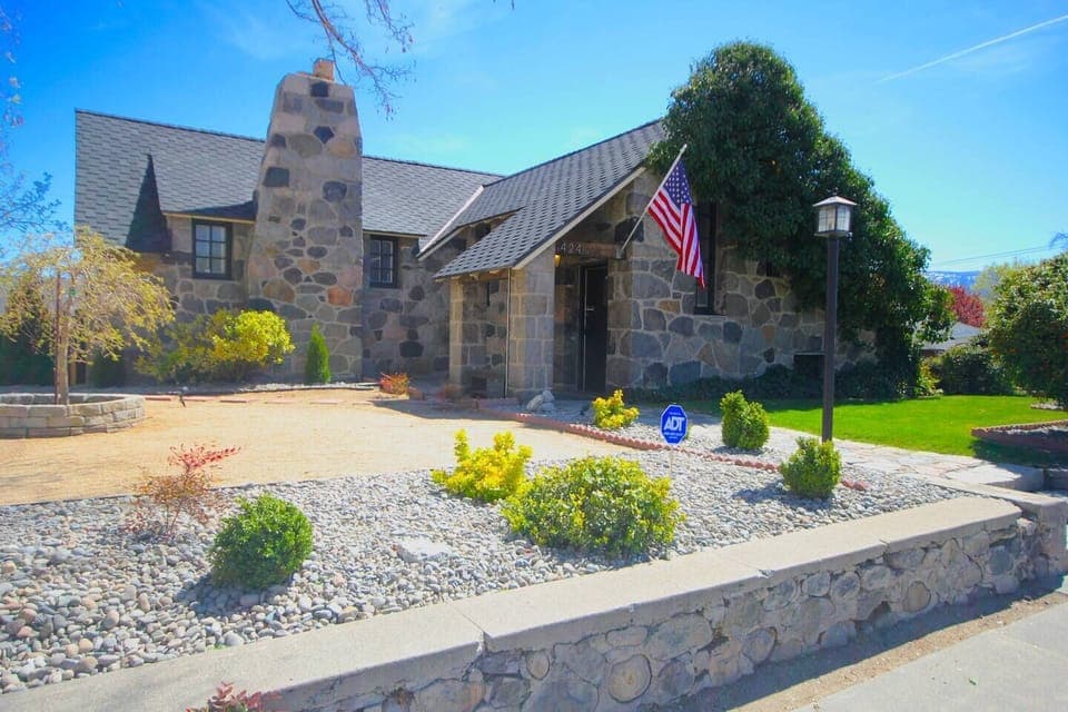 The spacious yard provides plenty of room for the kids to play.#stayrenostonehouse