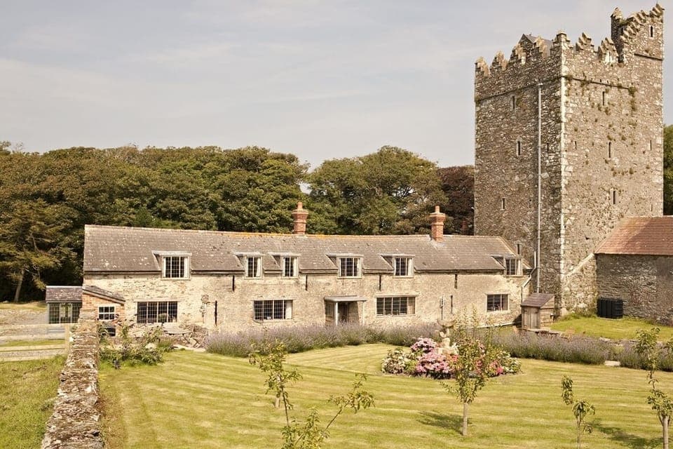 Both cottages in the long building with Butlerstown Castle