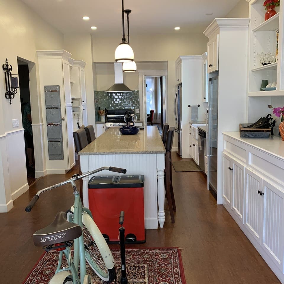 Roomy kitchen with barstools and lots of cooking essentials.