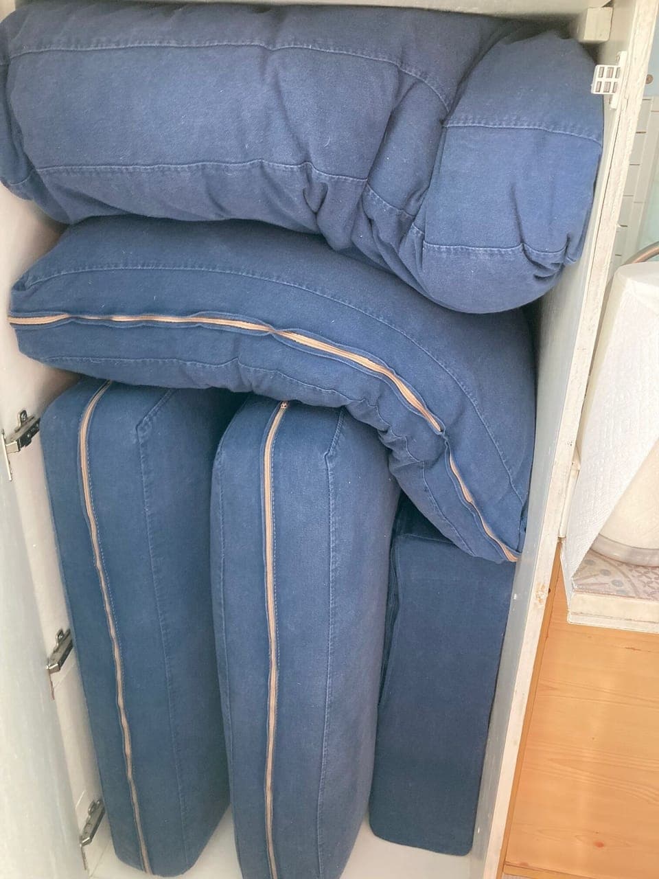 Storing the sofa cushions before pulling down the Murphy  bed.