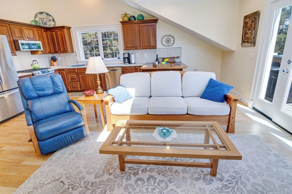 The living room welcomes you with a recliner and a Berkeley Mills sofa. 