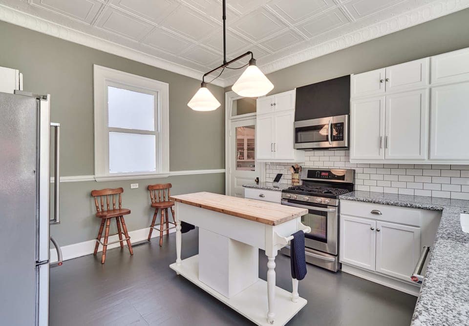 The white cabinets are stocked with all your kitchen needs
