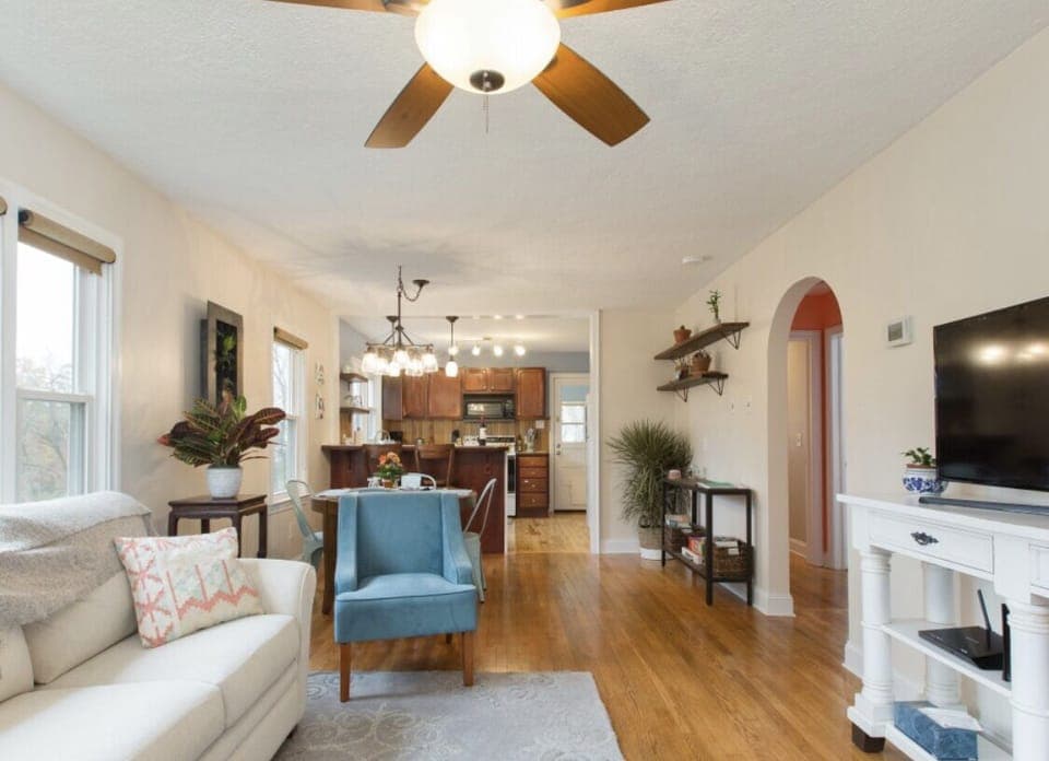 Comfortable living area boasts natural light, plants, and simple design. 