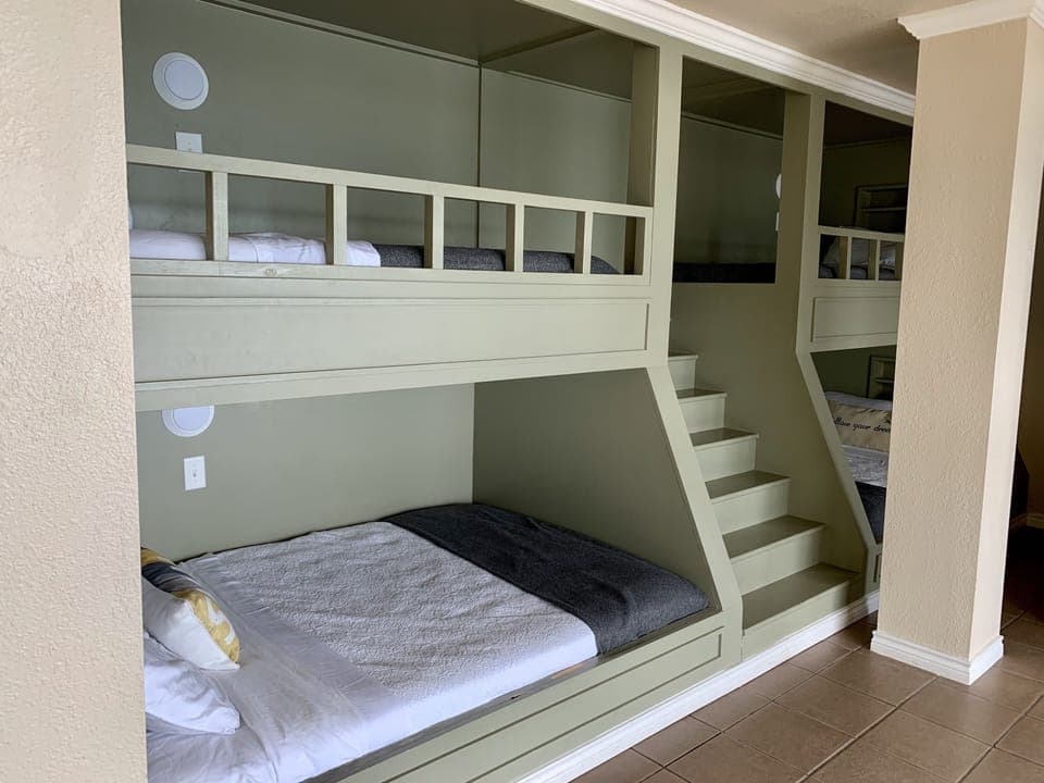 Bunkroom has amazing views, living area with TV, and access to expansive deck.