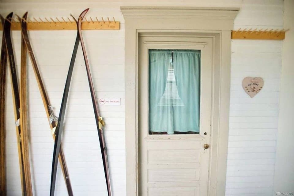 【Entryway Detail】 Vintage wooden skis — Leadville's mountain heritage, right in your entryway.