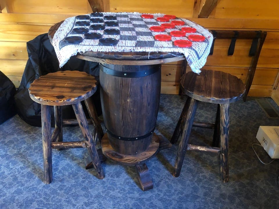 Checkers game with barrel table in the game room