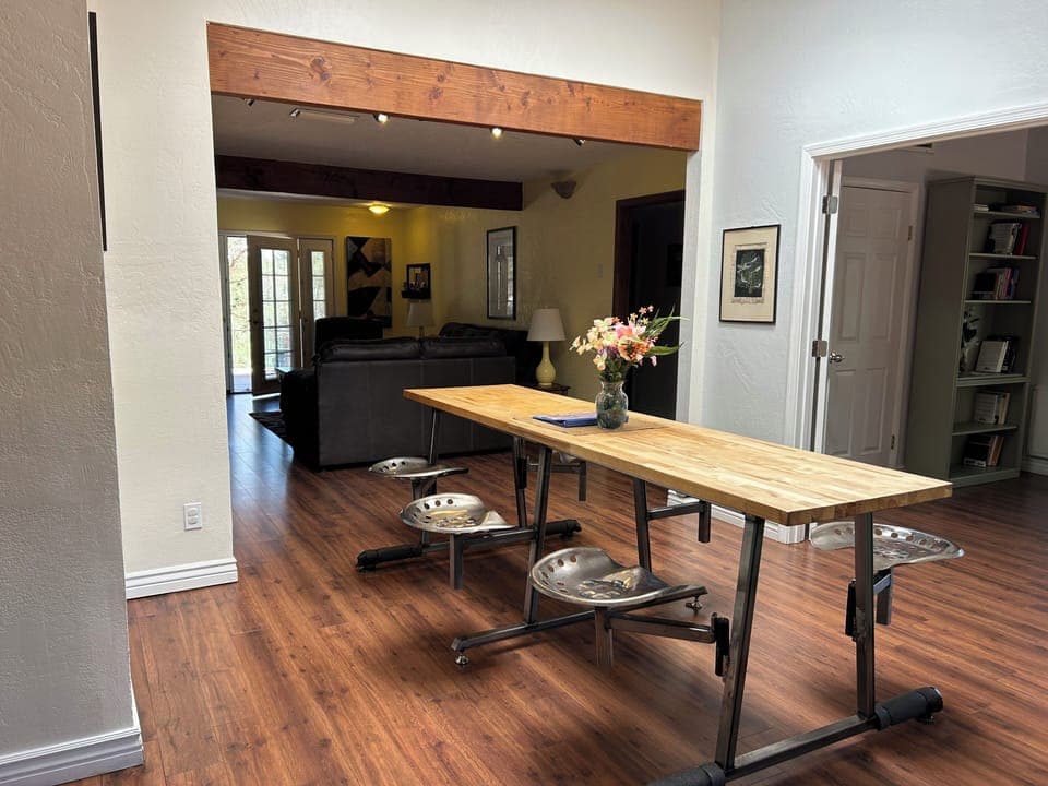 Butcher block table w/ 6 rotating tractor seats, cushions available.