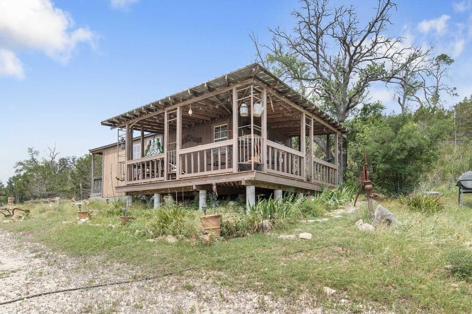 The wraparound porch on this elevated guest cabin offers astounding views of the surrounding Hill Country!