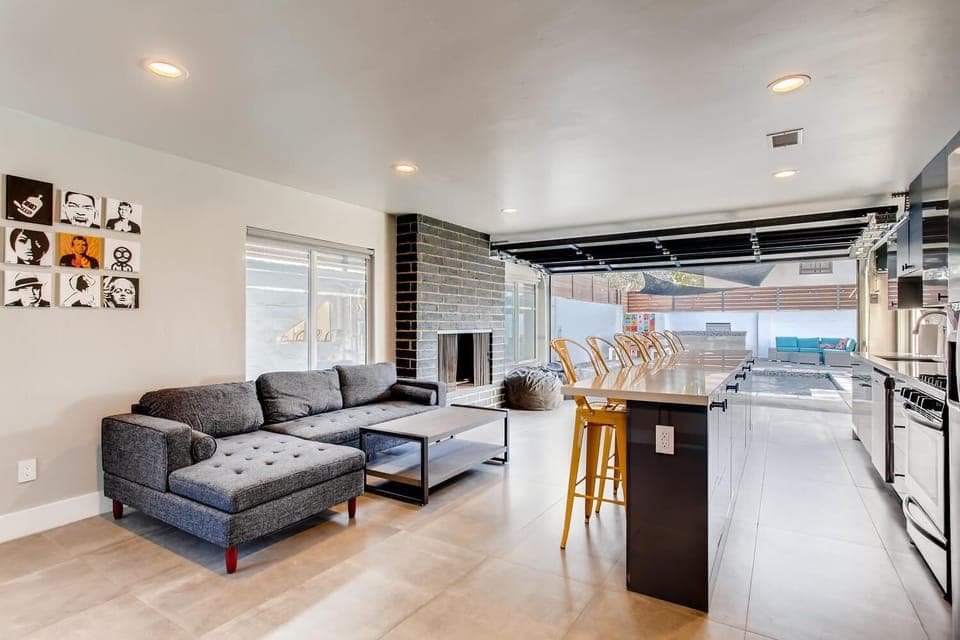 IN/OUT LIVING ROOM WITH FIREPLACE THAT FACES POOL, BBQ AND OUTDOOR LOUNGE