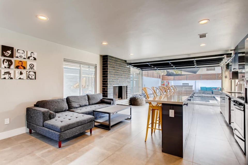 IN/OUT LIVING ROOM WITH FIREPLACE THAT FACES POOL, BBQ AND OUTDOOR LOUNGE