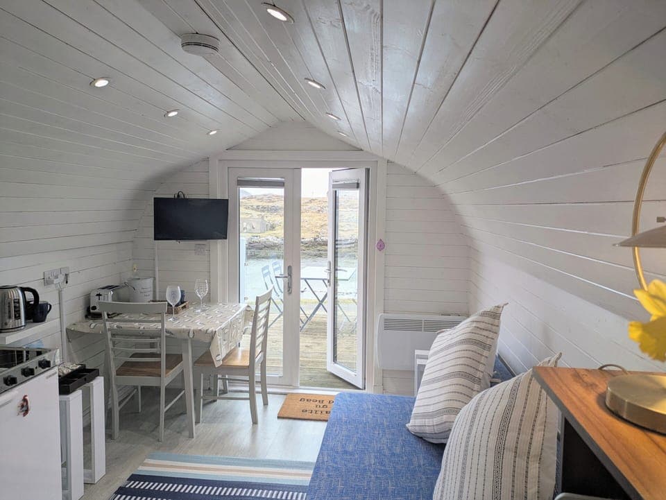 Bright living room/dining area with sofa bed and great view to the sea.