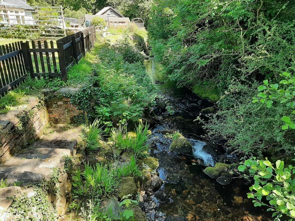 The river with steps leading down if you want to paddle and cool your feet. 