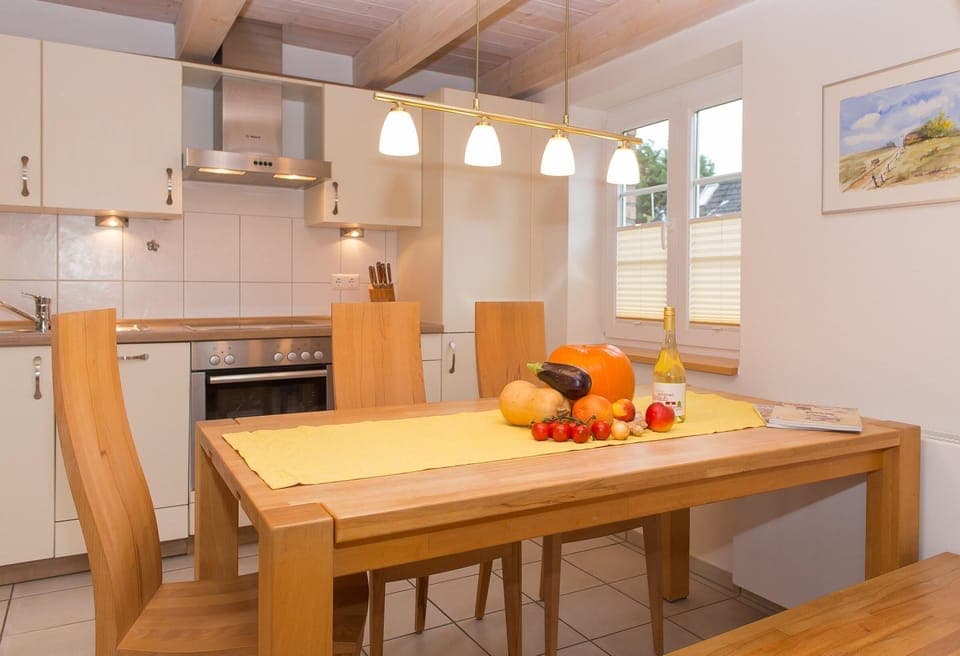 Kitchen & dining table in apartment Sonnendeck