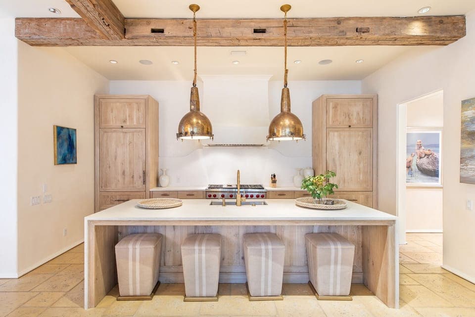 Kitchen with Island, Stools, Dual Refrigerators, and Ceiling Lamps.