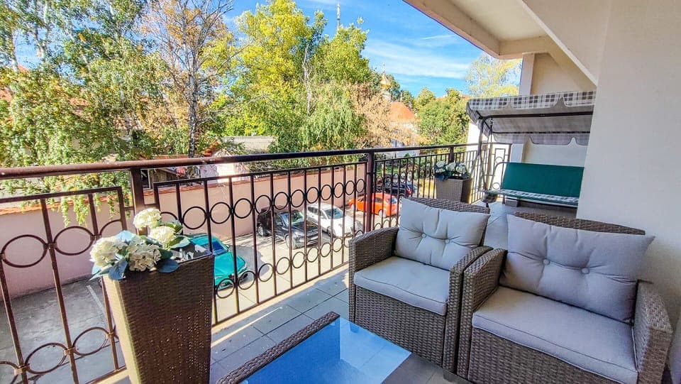 Large terrace overlooking a park with an old Orthodox churche