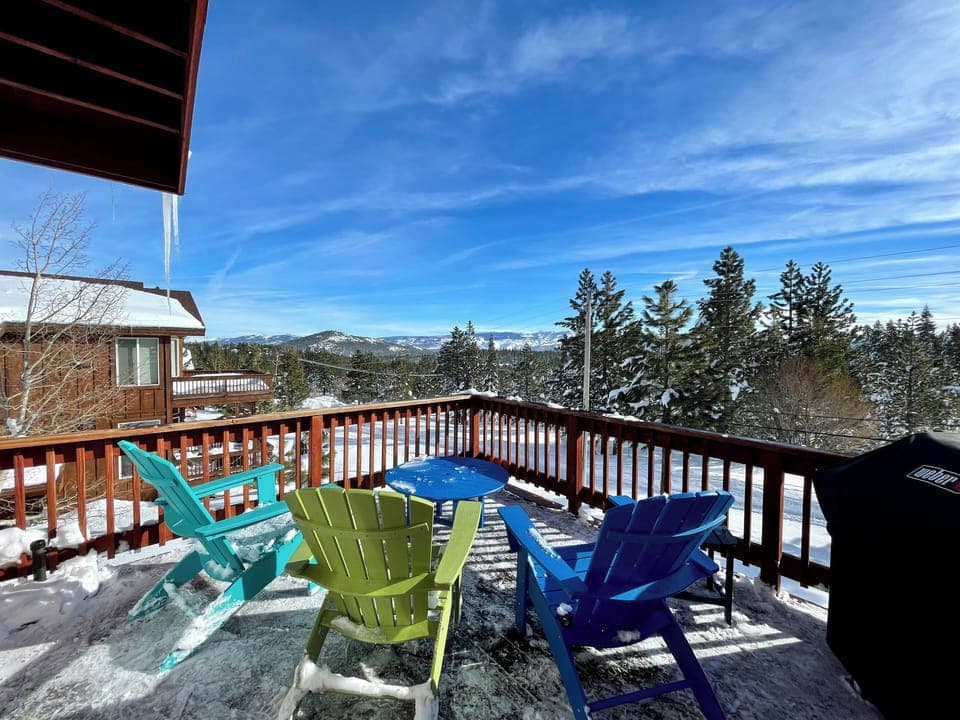Deck with sunrise view, 3 Adirondack chairs, table, umbrella, and gas BBQ.