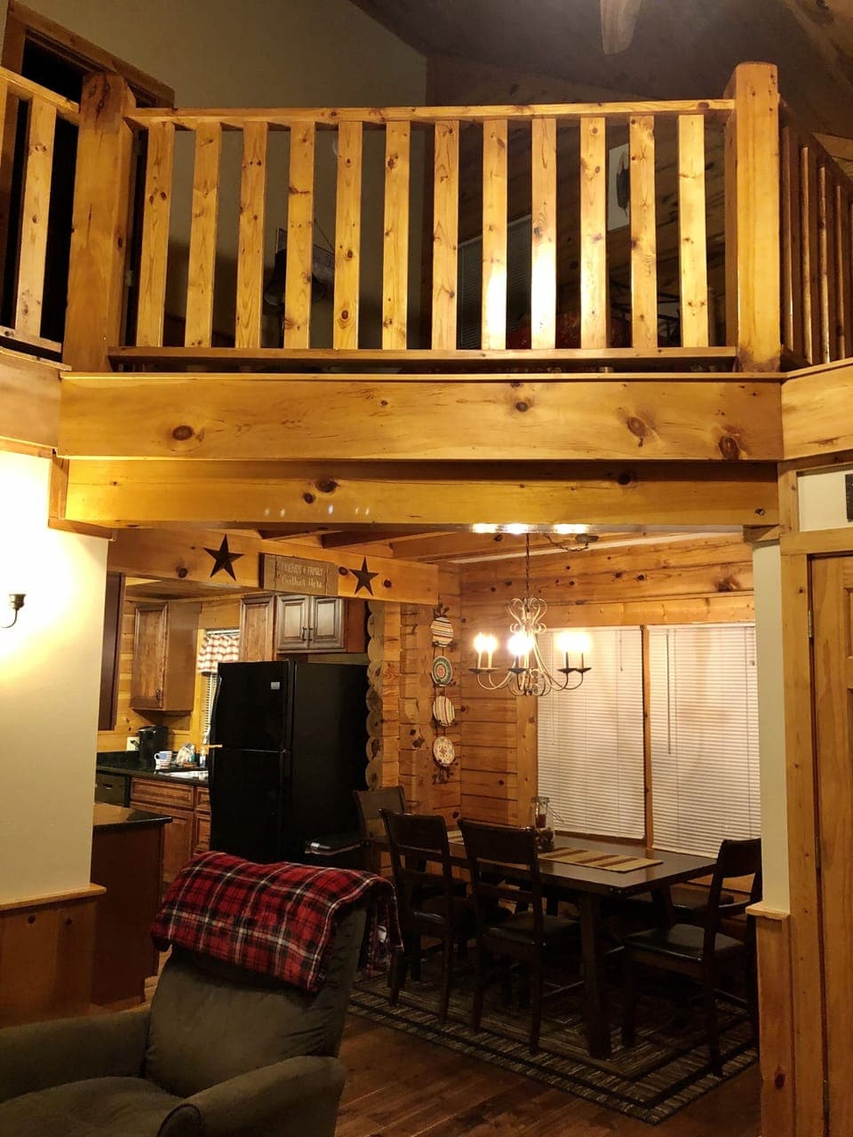 view of the dining area with loft above.