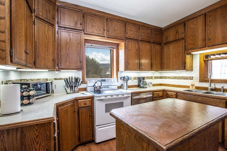 Kitchen has all the pots, pans and necessities for cooking. 
