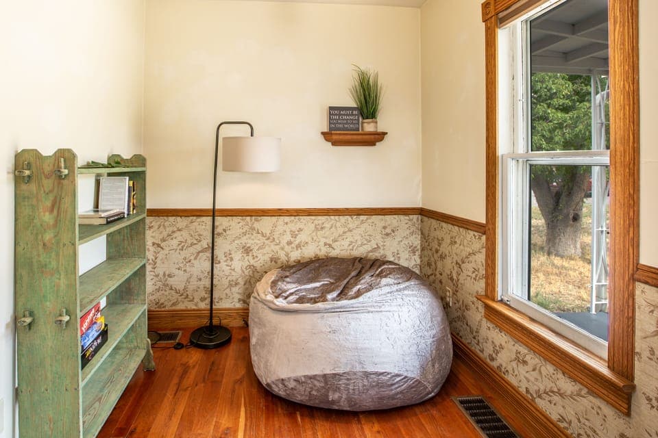 Corner of living room has a cozy reading nook to relax in.