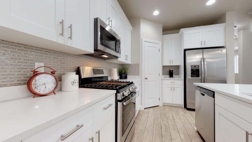 Fully stocked gourmet kitchen featuringstainless steel appliances