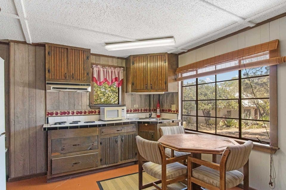 A fridge, microwave, and stove top are included in the Casita kitchen, alongside a handy dining nook.