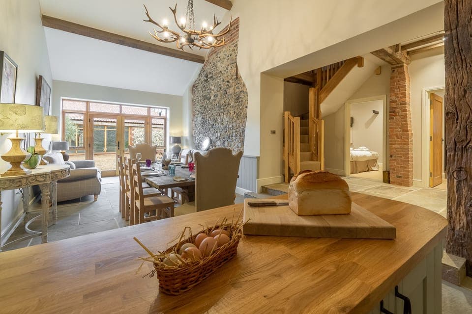 Ground floor: View from kitchen to dining and snug area, ground floor bedrooms and stairs to the first floor